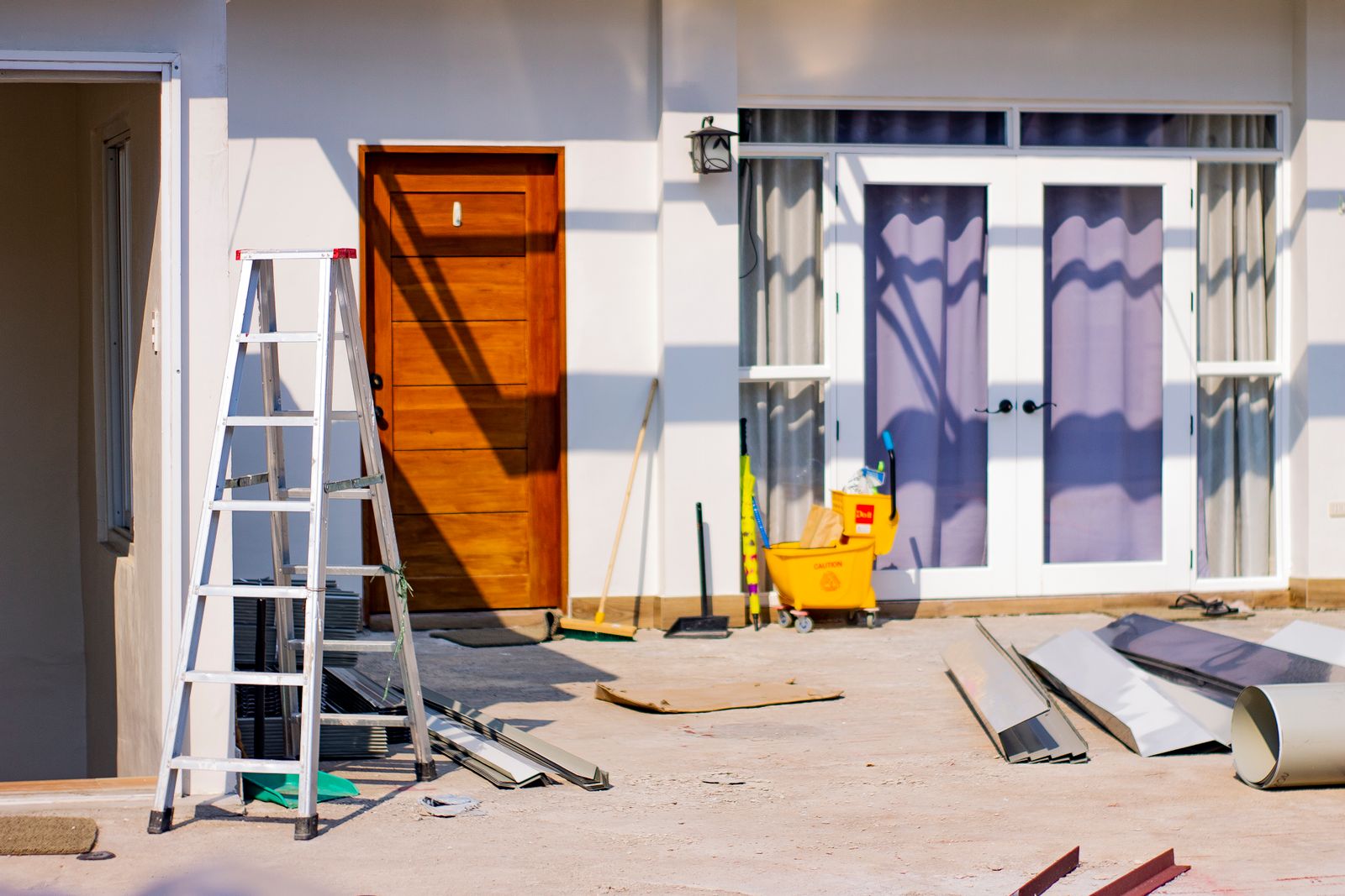 House façade with a new wood door and exterior work in progress