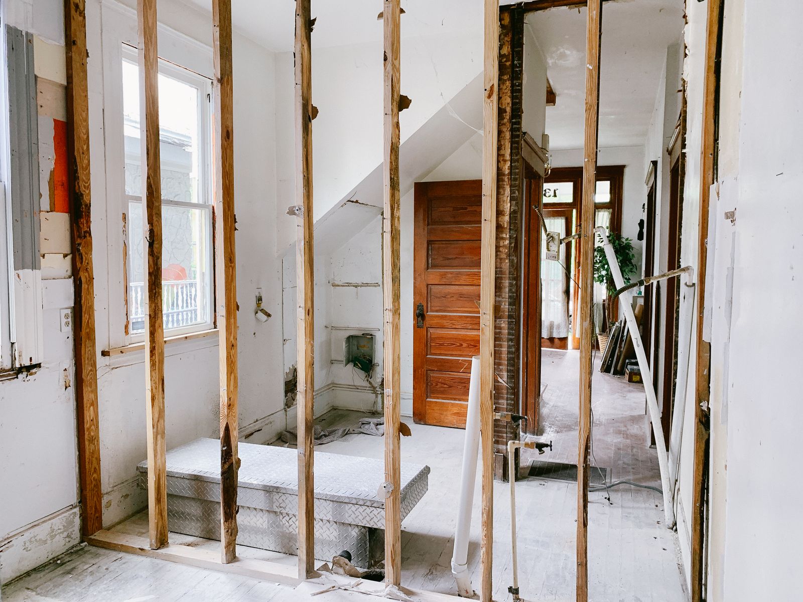 Home interior with partitions opened up and timber framing exposed